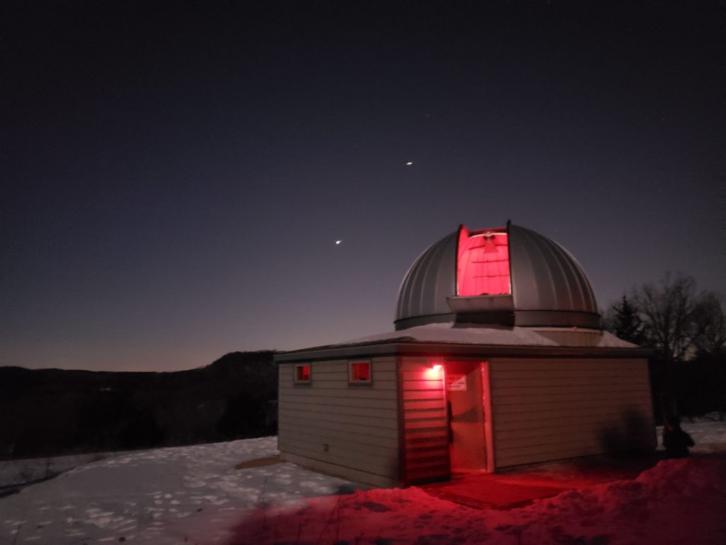 The Observatory illuminated by red lights at night in the winter.