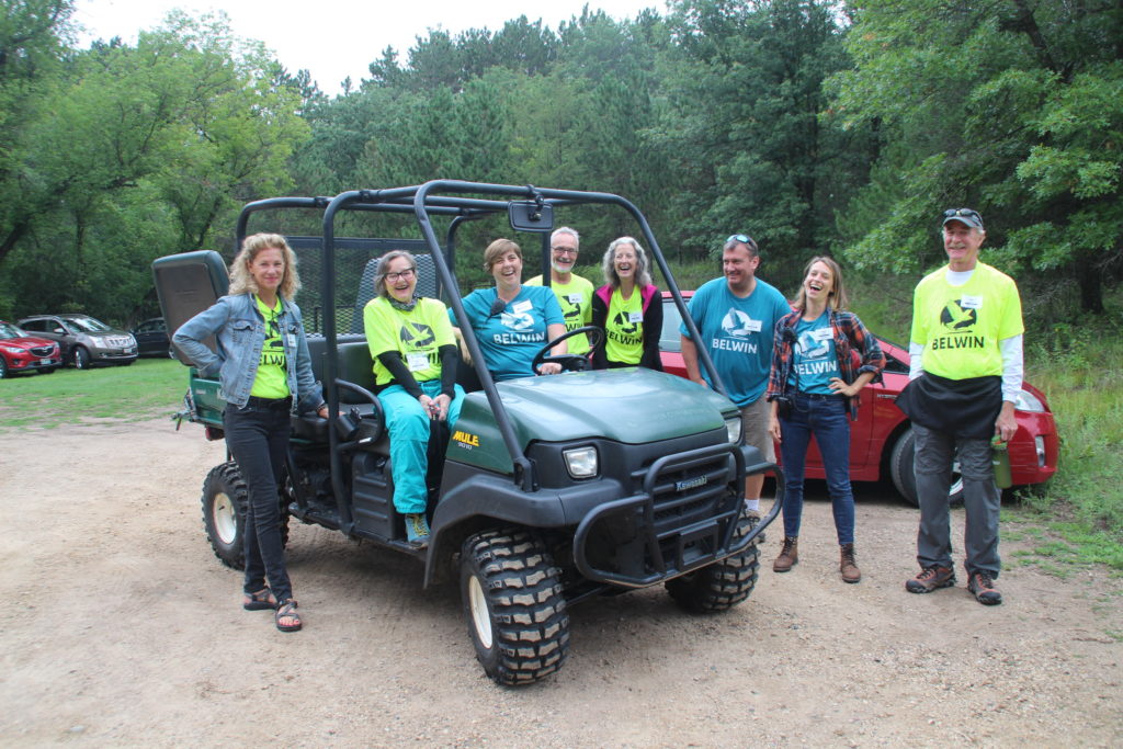Group of smiling people near can-am